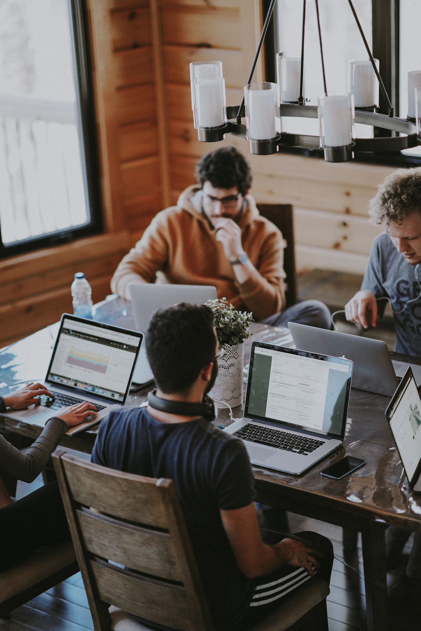 Illustrative stock photograph of a small team reviewing work around a shared table