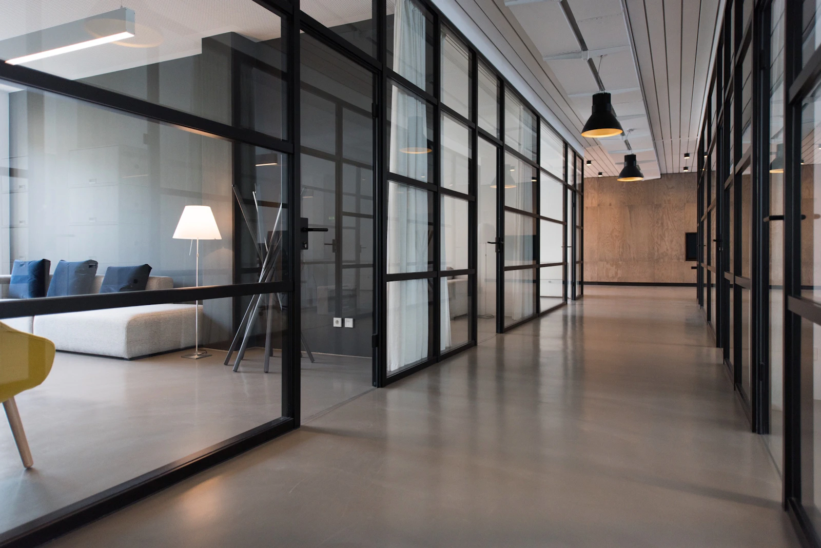 Illustrative stock photograph of a contemporary workplace with glass meeting rooms