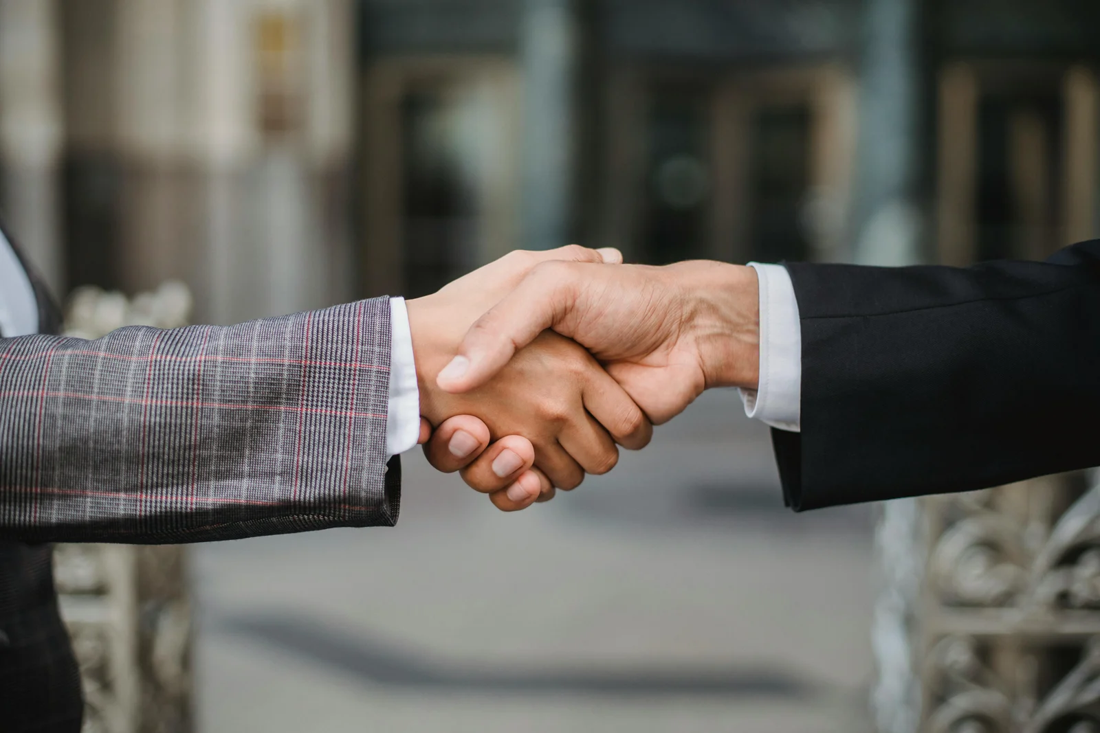 Illustrative photograph of two professionals shaking hands